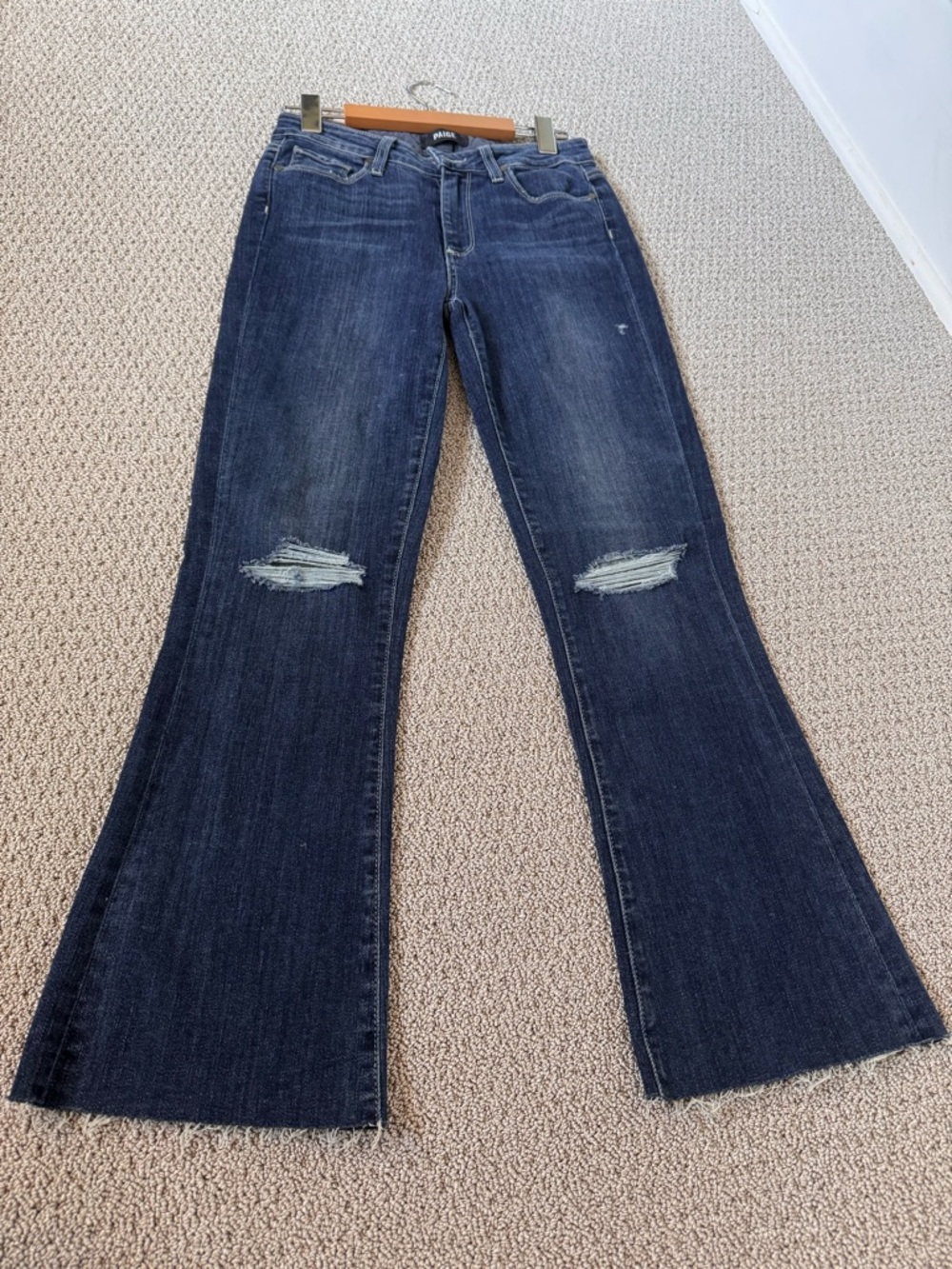 Paige Jeans ‘Colette Crop Flare’ in distressed darker blue with fray bottom.